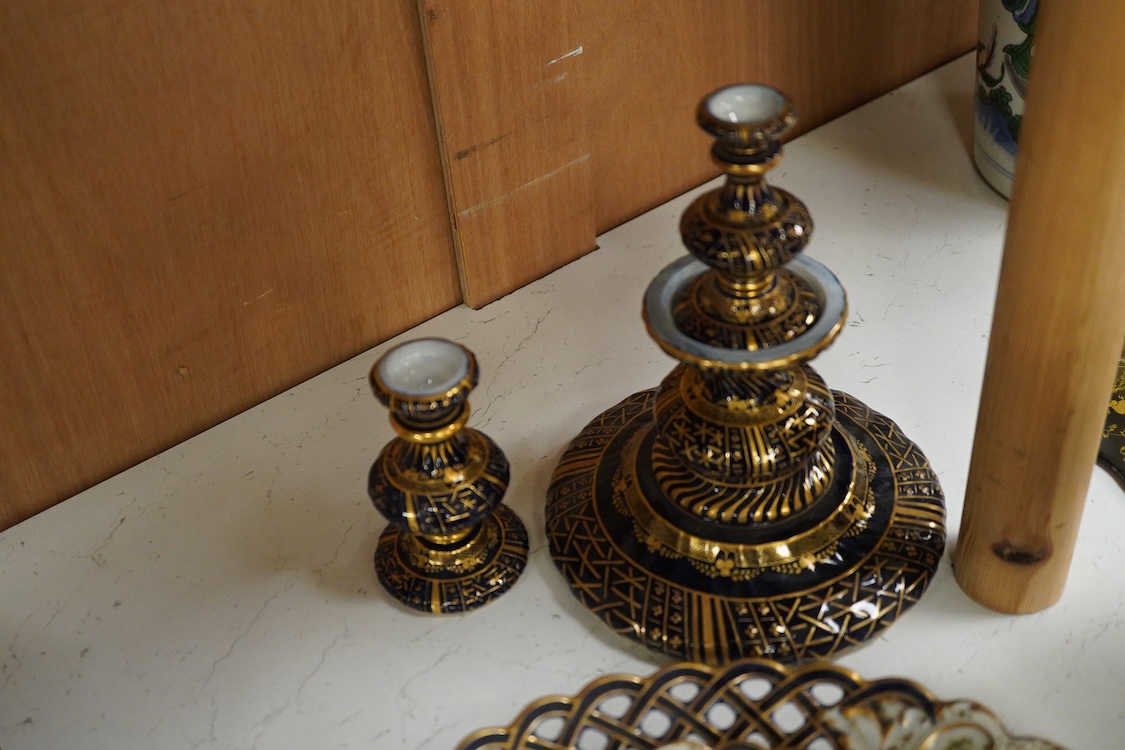 A pair of late 19th century Meissen three tier cake stands with figural tops, 48cm high